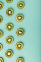 The patterns of the slices of kiwi fruit on green background as a continuous background. photo