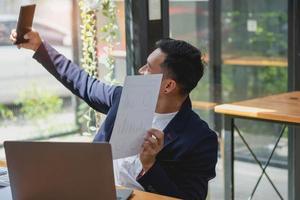 Marketing, Financial, Accounting, Planning, businessman uses a mobile phone to contact a customer to inform her of the company is business partnership. photo