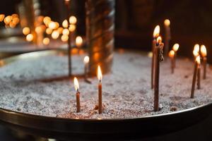 Candles in the Church, yellow lights and prayers. photo