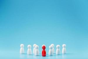 The leader in red leads a group of white employees to victory, HR, Staff recruitment. The concept of leadership. photo