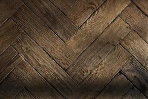 The texture of the old wooden floor, the diagonal arrangement of the parquet Board. photo