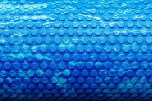 Abstract texture of a blue massage roller in the form of blue hexagonal cells. The entire screen as the background. photo