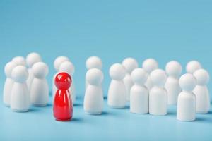 The leader in red leads a group of white employees to victory, HR, Staff recruitment. The concept of leadership. photo