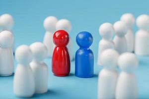 Choosing a sexual partner for love, relationships from such a crowd of monotonous people. A red woman and a blue man in a crowd of white people. photo