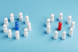 Two different Groups of white people stand around the blue and red leadership candidates separately. Competition in business between the firms and the teams. photo