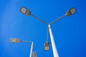 street lamps on a pole against the sky photo