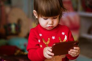 Concept of holidays, kids and technology - happy smiling little girl photo
