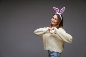 a girl in bunny ears on a gray background photo