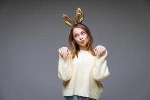 beautiful young woman with ears posing on background photo