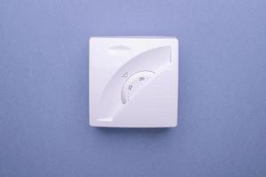 White thermostat showing the temperature in celsius in the house. The concept of saving gas and electricity. photo