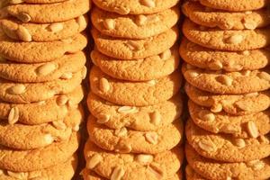 Rows of delicious round cookies with nuts. photo