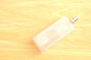 Plain oil bottle on a wooden background photo