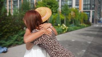 Two women friends meeting up casually on the street video