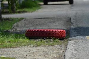 Red tread wheels on the side of  road photo