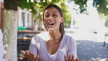 Young woman tells an story outside video