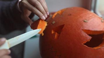 Close up on Hands and Knife Carving a Pumpkin video