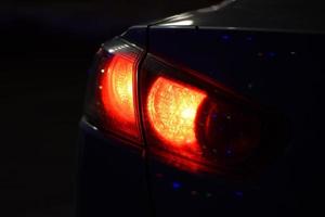 Discounted rear car lights in the dark. Stop signals photo