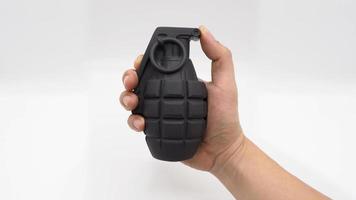 Man hand and military bomb plastic model toy. photo