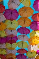 Multicolored open umbrellas as street shelter. photo