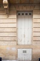 Traditional house with wooden door and cellar entrance below. photo