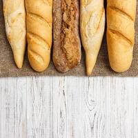 Assortment of fresh French baguettes on a wooden table photo