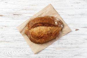 Loaf of bread on a grocey paper bag in european style. top view photo