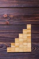 A wooden blocks cube over black wooden textured background with copy space for add word text title. Concept or conceptual Wood block stair or six steps. Cubic photo