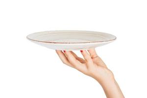 One white kitchen plate on human hand. perspective view, isolated on white background photo