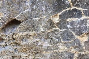 Close up view at a natural limestone wall in the mountains. photo