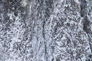 Close up view at a natural limestone wall in the mountains. photo