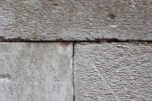 Detailed view on aged concrete walls with cracks and a lot of structure in high resolution photo