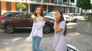 Two women explore city together on a sunny day video