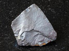 Hematite ore on black granite photo