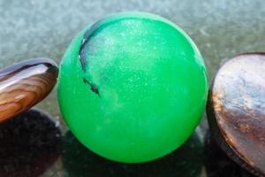 bead from green Aventurine gemstone on dark photo