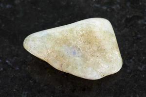 tumbled labradorite gemstone on dark photo