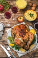 Baked chicken, mashed potatoes and wine glasses for dinner on the festive table. photo