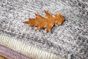 Crumpled gray knitted clothes folded in a pile. Texture for background or illustrations photo