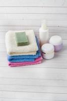 Spa and Wellness concept on white background. Towels cream soap and bath accessories. Copy space photo