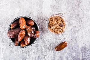 Bowl with date pit powder for making coffee on the table. Caffeine Free Alternative to Coffee. Top view photo