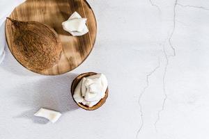 Pieces of ripe coconut on the table. Tropical fruits. Natural source of antioxidants. Top view photo