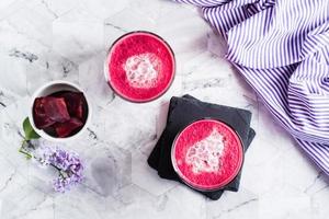 Delicious beetroot latte in glasses on the table. Healthy homemade vitamin drinks. Top view photo