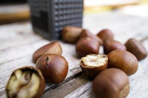 Fresh chestnuts isolated on a wooden floor, chestnuts have an oily sweet taste. photo