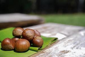 Fresh chestnuts isolated on a wooden floor, chestnuts have an oily sweet taste. photo