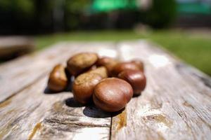 Fresh chestnuts isolated on a wooden floor, chestnuts have an oily sweet taste. photo