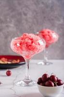 Summer drink frozen wine slushy in glasses on table. Refreshing alcoholic cocktail. Vertical view photo