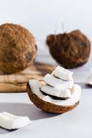 Pieces of ripe coconut on the table. Natural source of antioxidants. Vertical view. Close-up photo