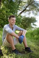 young man resting after cleaning the park photo