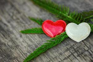 red and white heart lie on wooden background, the concept of romance and love photo