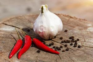 garlic and pepper on a wooden background close-up photo