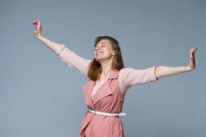 Positive emotions. Portrait of an excited caucasian woman in pink clothes photo